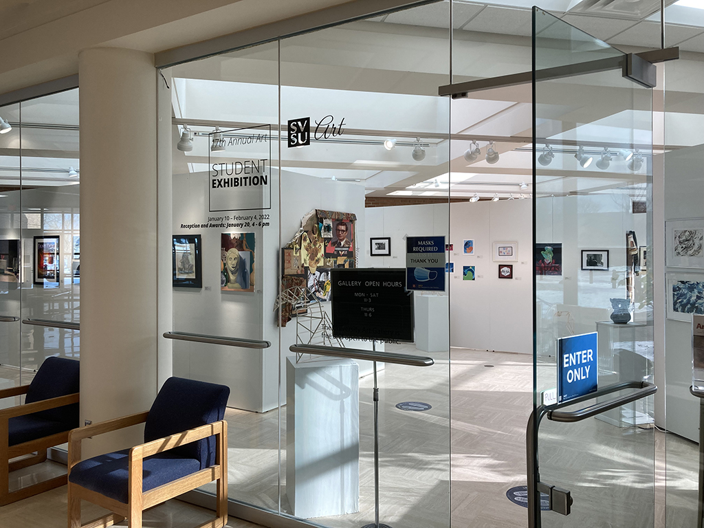 Entrance to gallery with 17th Annual Art Student exhibit sign and various works